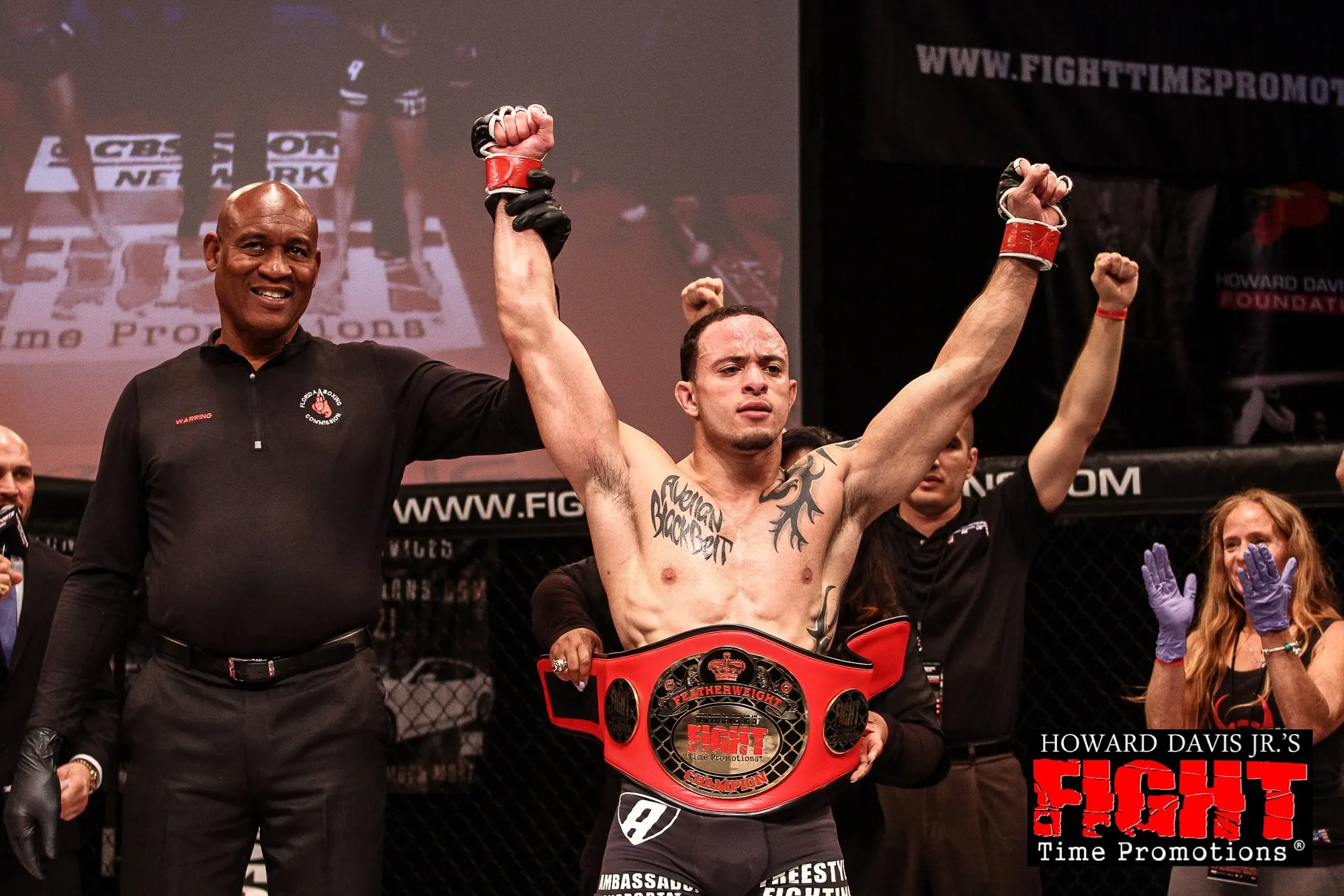 Jason “The Specimen” Soares having his hand raised with the championship belt after a Fight Time MMA title win